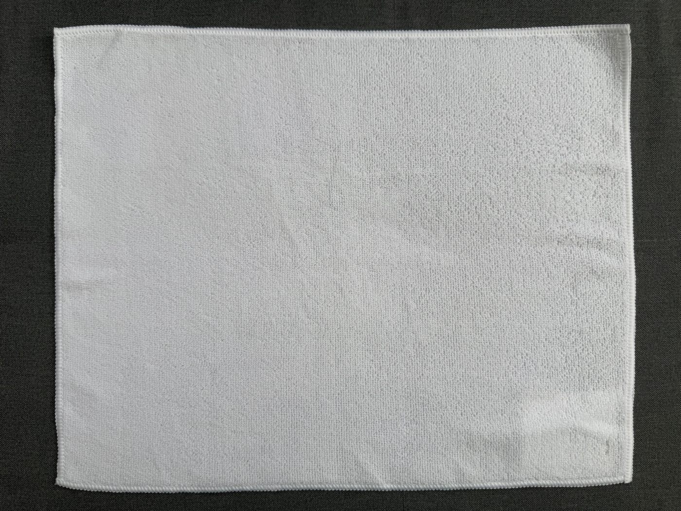 Bleached-white microfiber towel, 45 × 38 cm, overlocked on all four sides